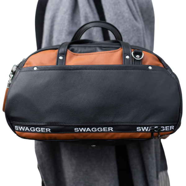woman holding the Travel Bag from Swagger leather with no background.